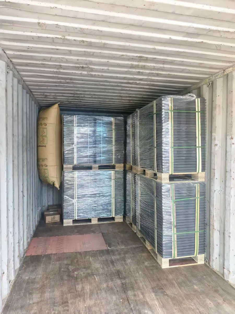Packed raised floor pallets arranged inside a shipping container