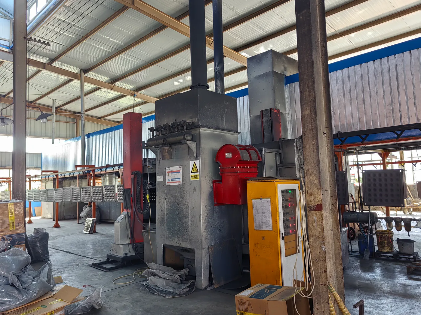 Powder coating line with suspended steel raised floor panels